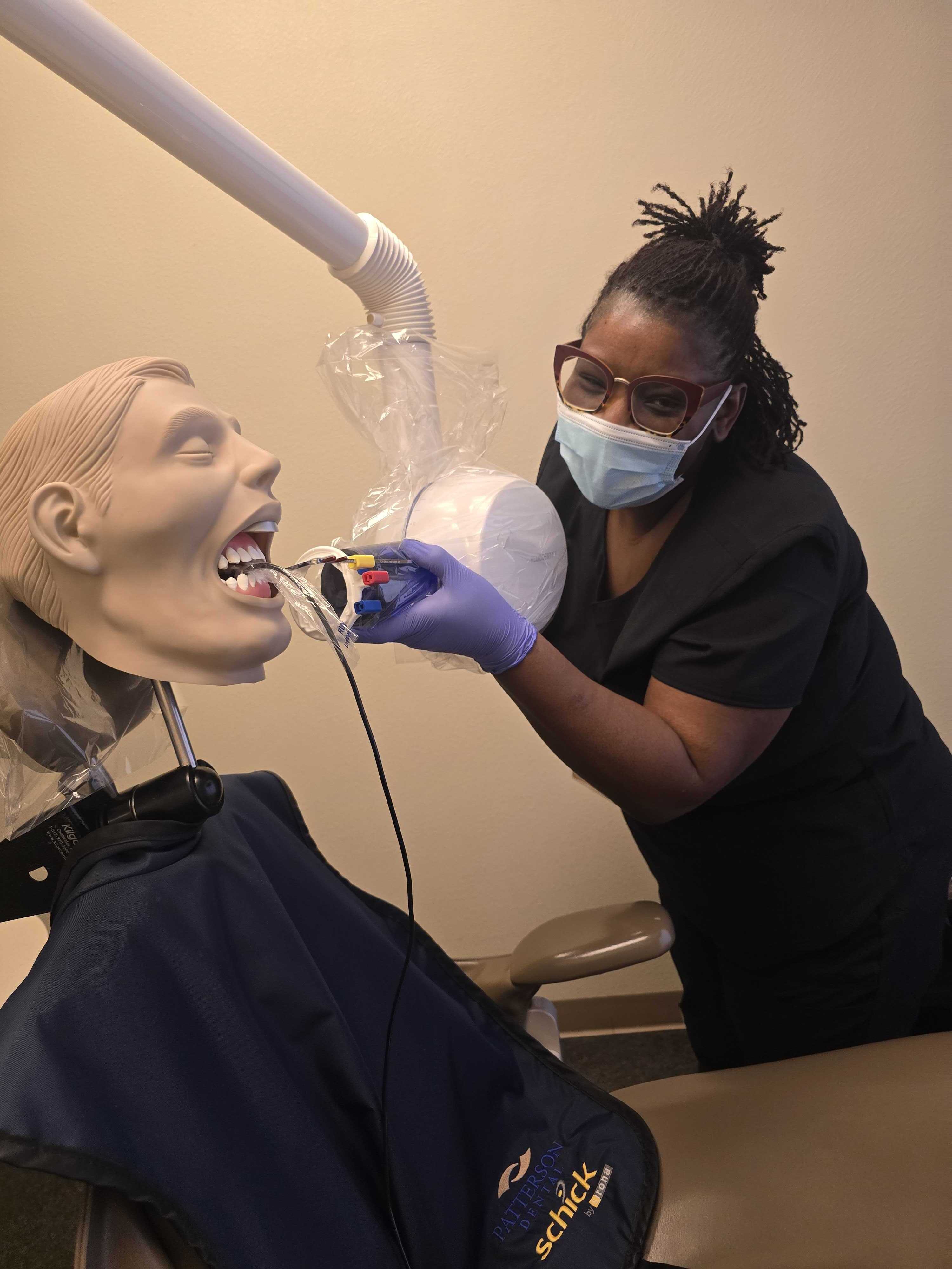 dental assistant student training to capture X-rays